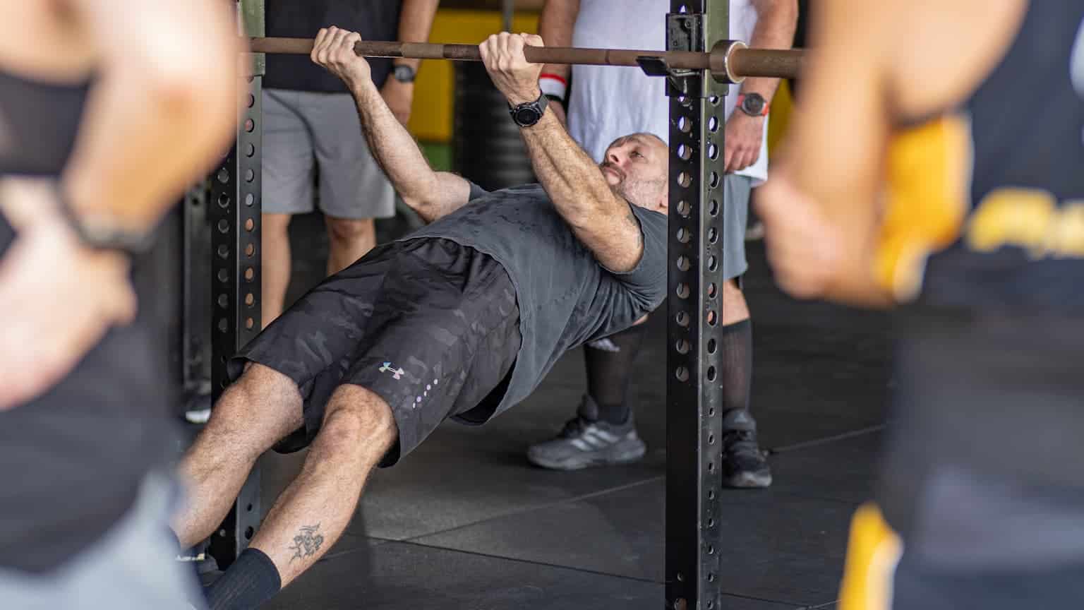 Men pushing their limits in a group strength training session