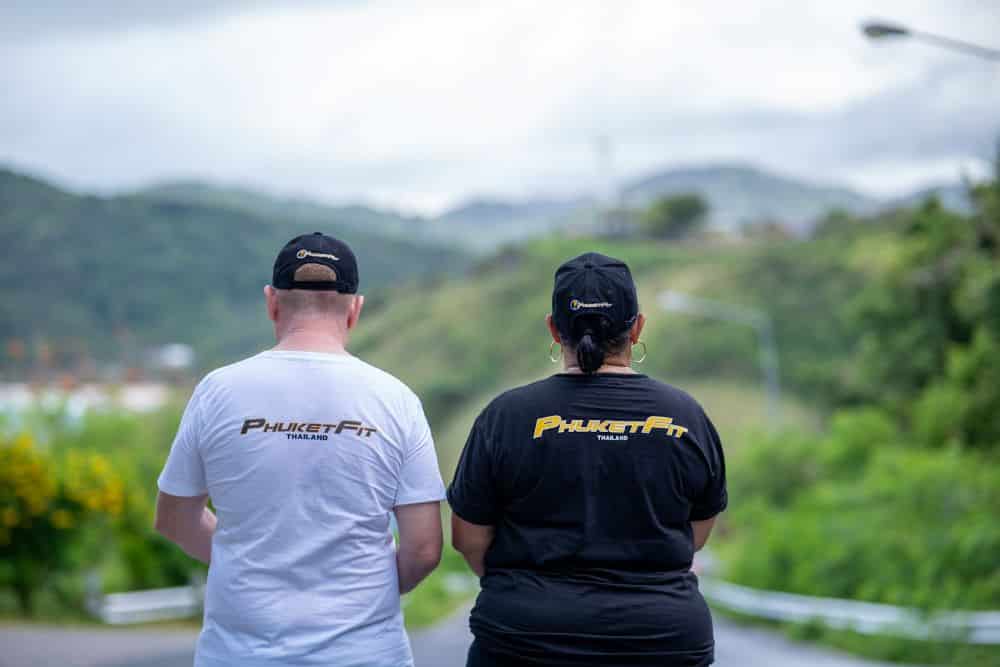 A couple walking together down Phromthep Cape