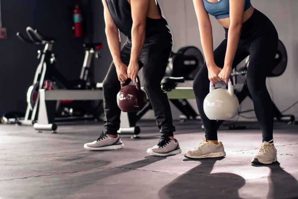 A couple lifting weights together