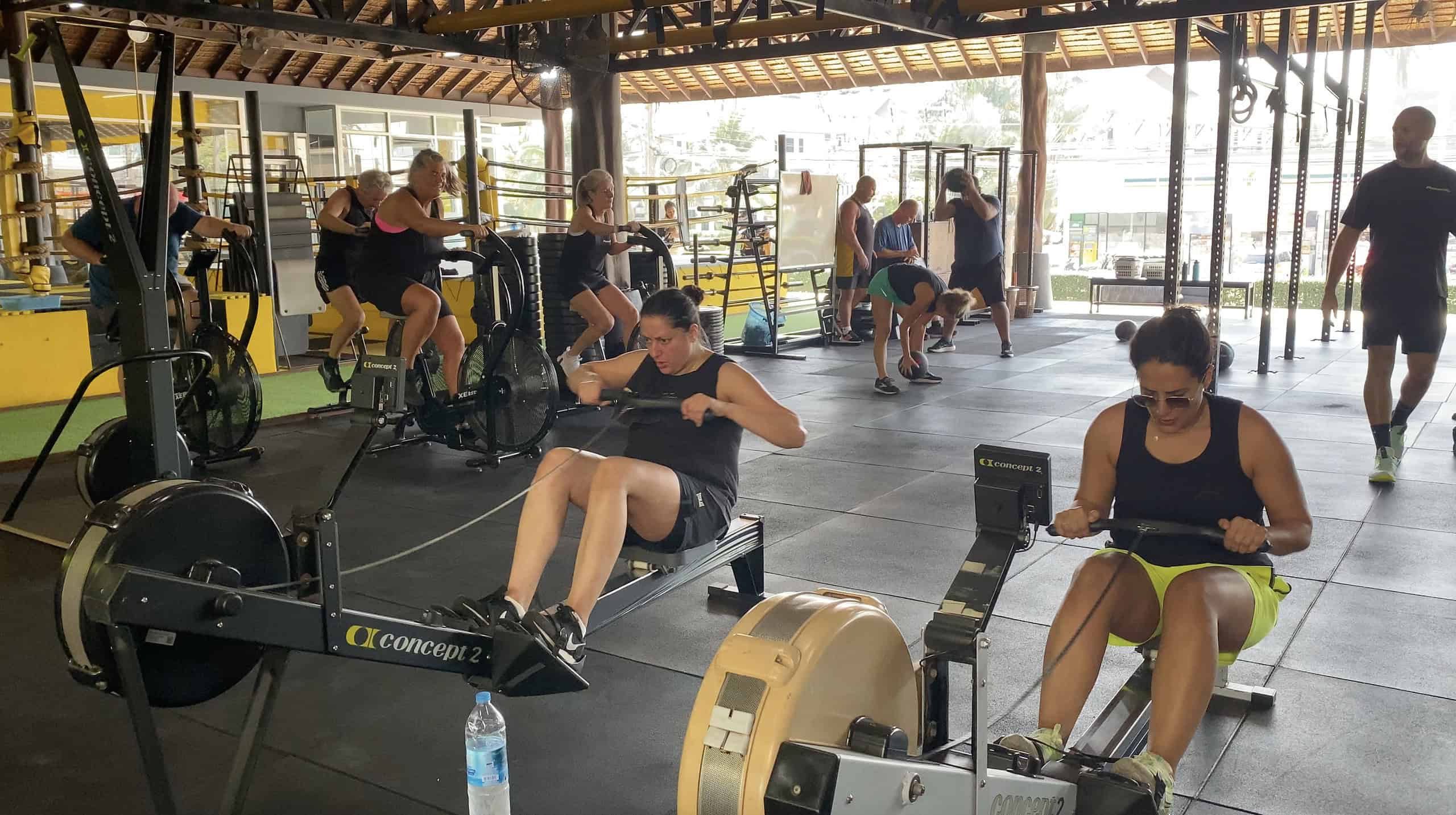 A group of people training together in a fully equipped gym during a wellness and fitness retreat in Thailand.