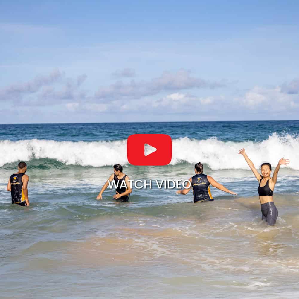 phuketfit guests enjoying the waves after a beach bootcamp workout at thailand fitness retreat