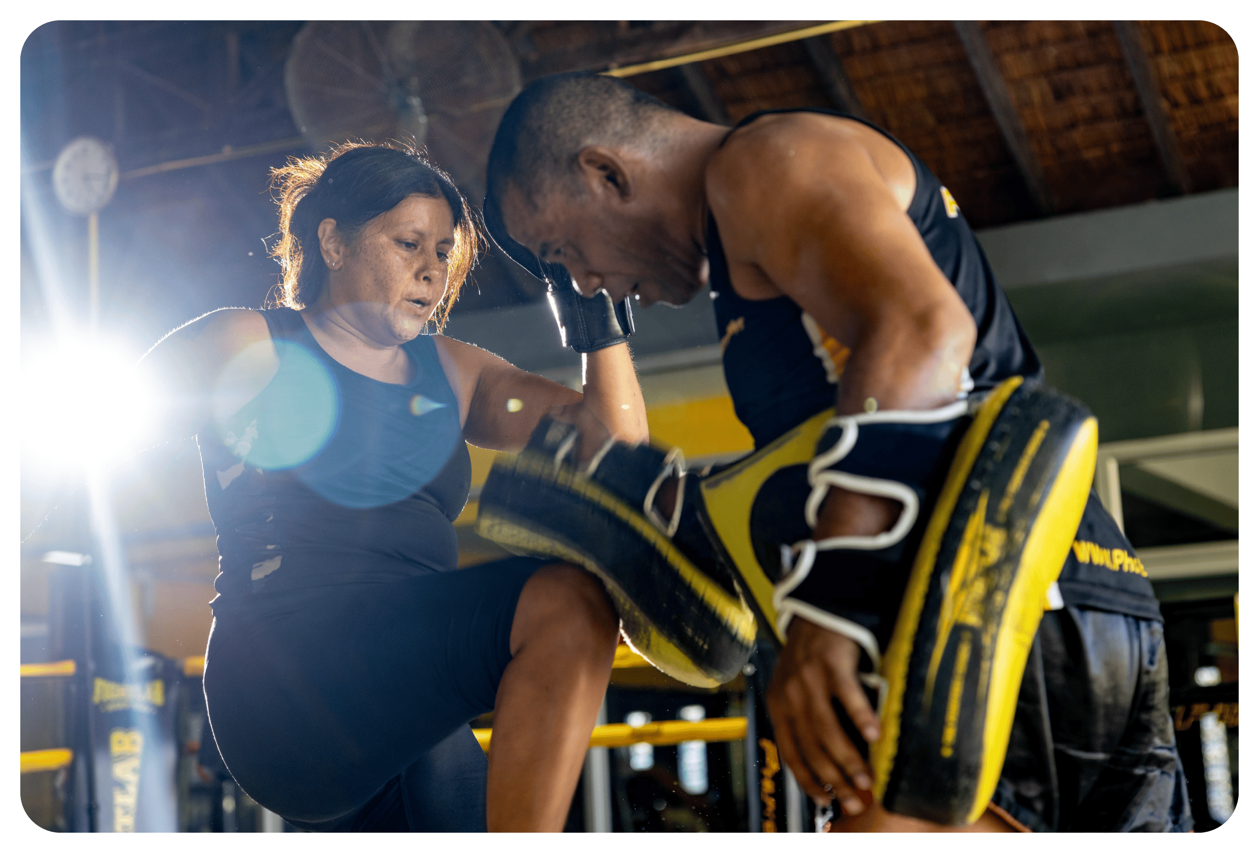 photo of phuketfit guest raising knee under coach instruction