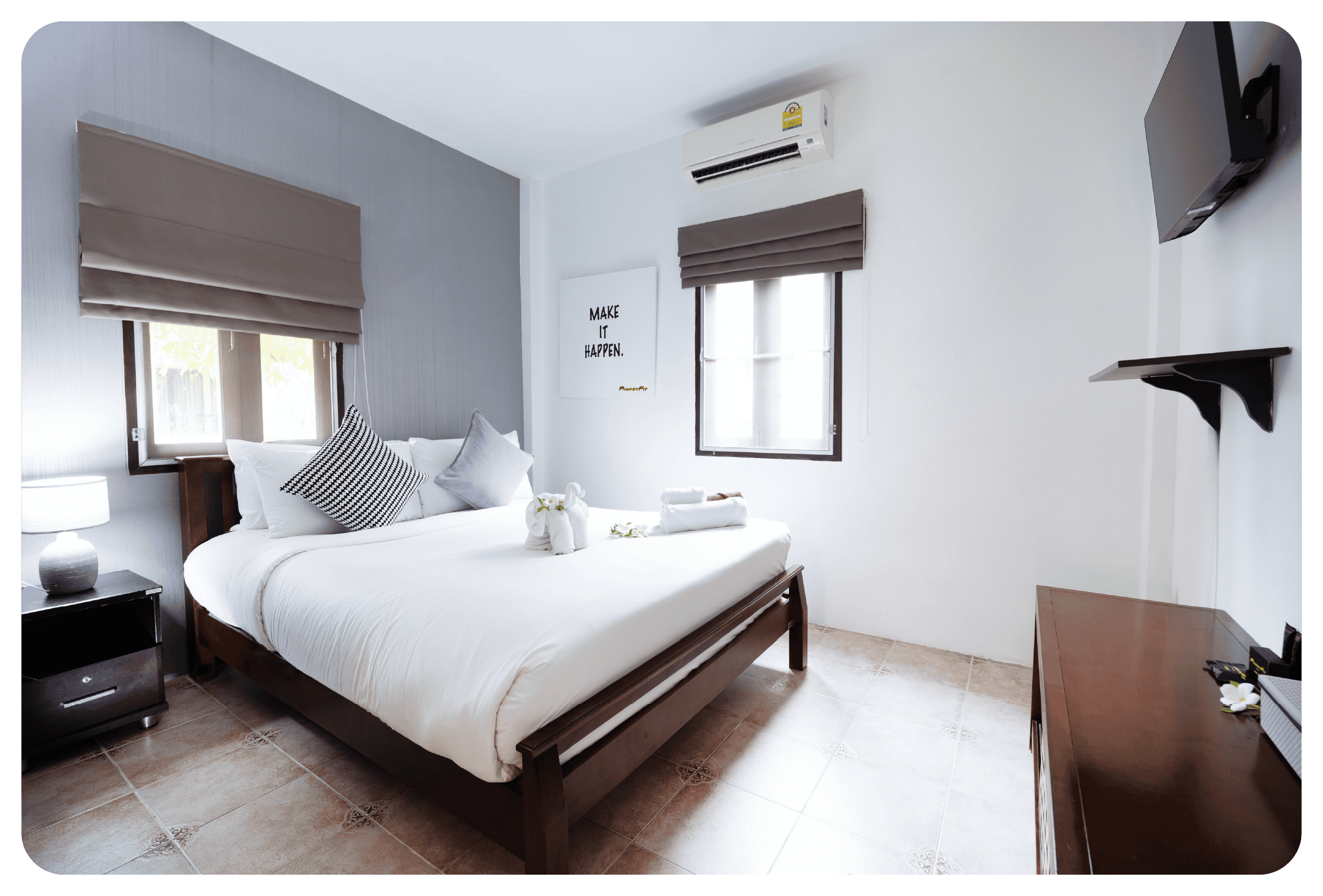 photo of double bed and furniture inside phuketfit single room accommodation