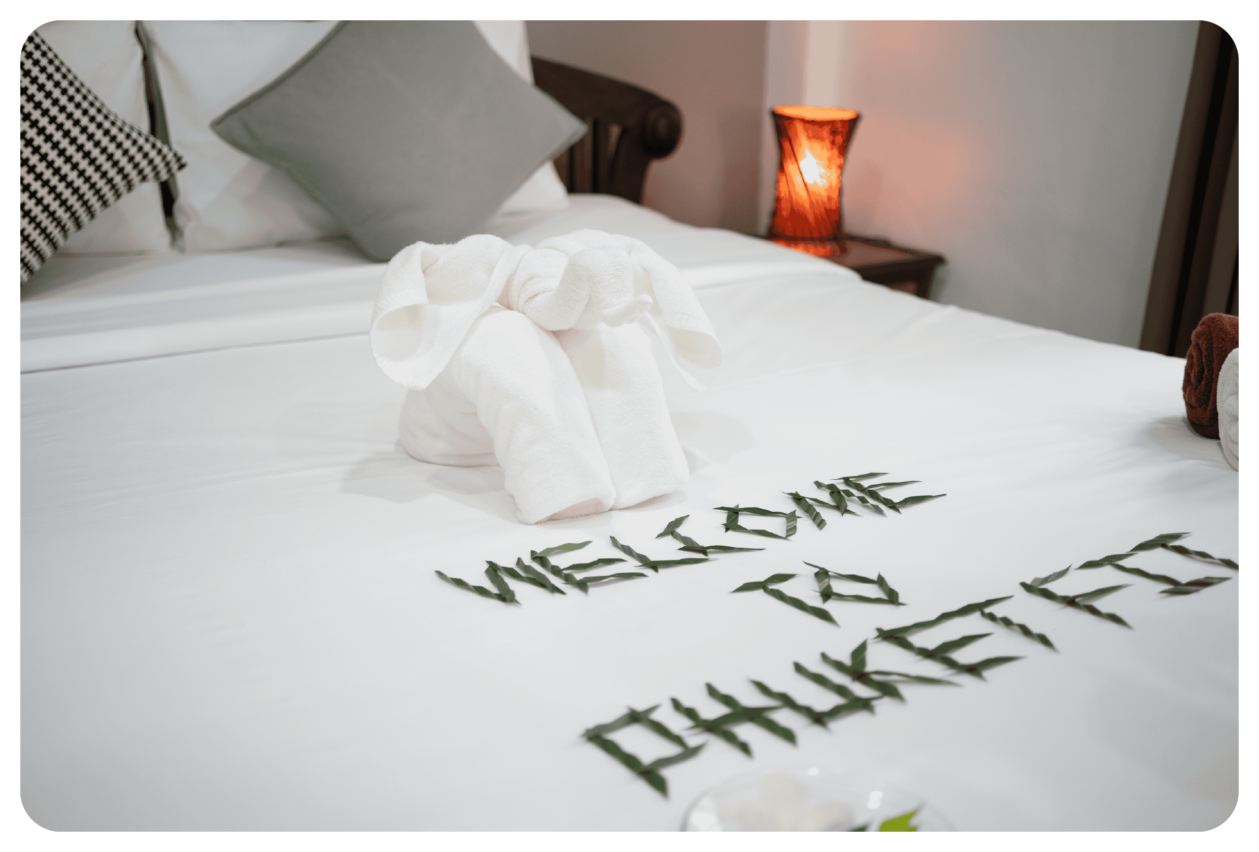 photo of letters arranging "Welcome to PhuketFit" on double bed at phuketfit accommodation