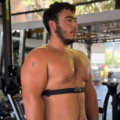 Man using heart rate training to monitor workout intensity at the gym